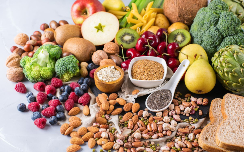A variety of fruits and vegetables on a white surface