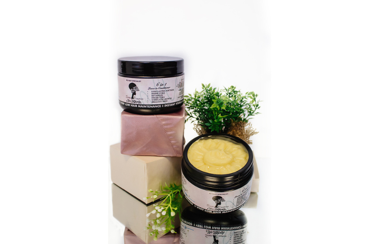 Conditioner bottles on top of small boxes next to a flower pot Conditioner bottles on top of small boxes next to a flower pot