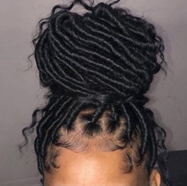 An image of a lady who has plaited black hair on her head.
