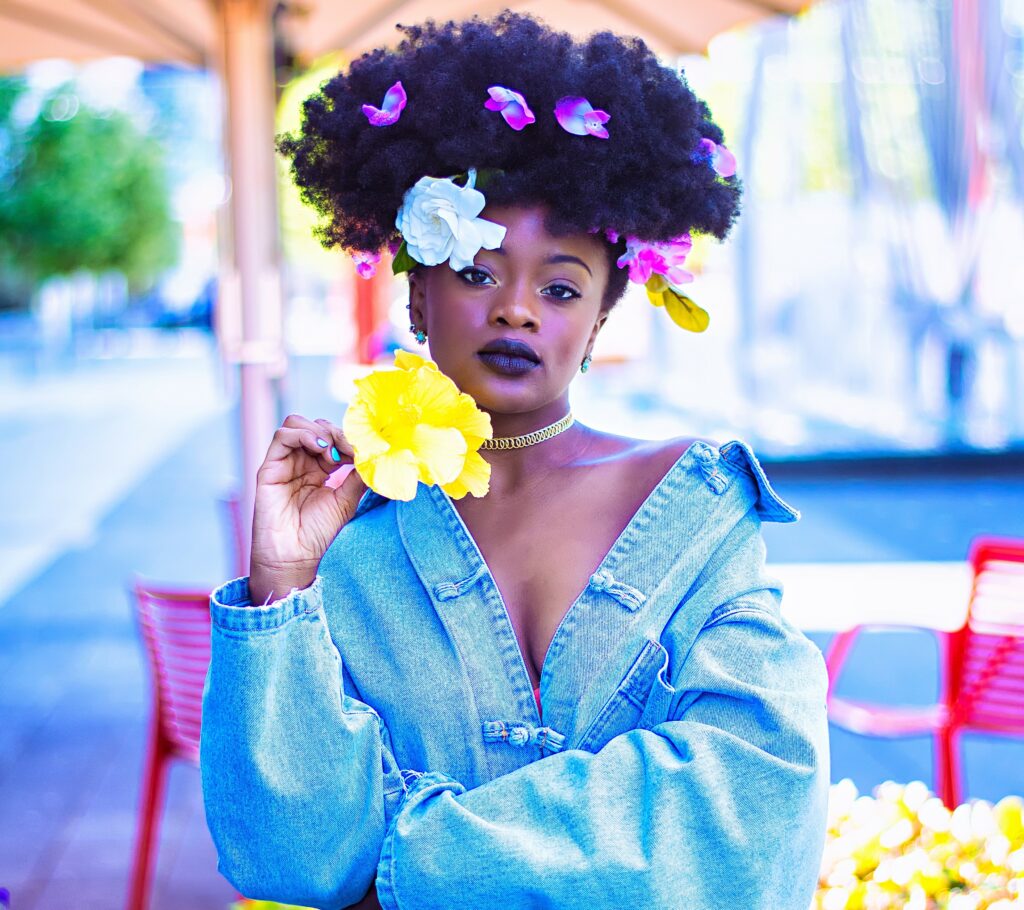 An image of a lady who has black hair on her with flowers in it.